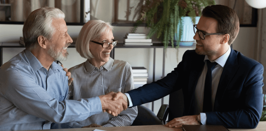 Lawyer shaking hands with elderly clients