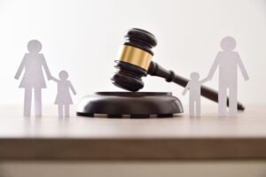 gavel with family cut-outs representing a court modifying a custody conflict agreement for the custody of children in a divorce.
