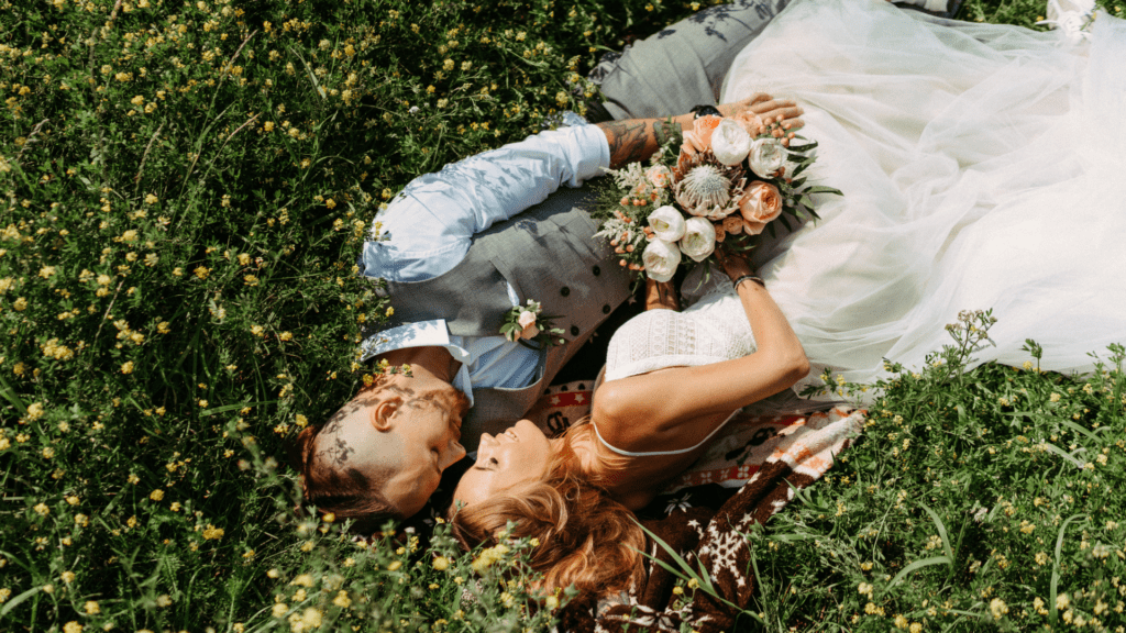 Wedding Couple Laying in Grass